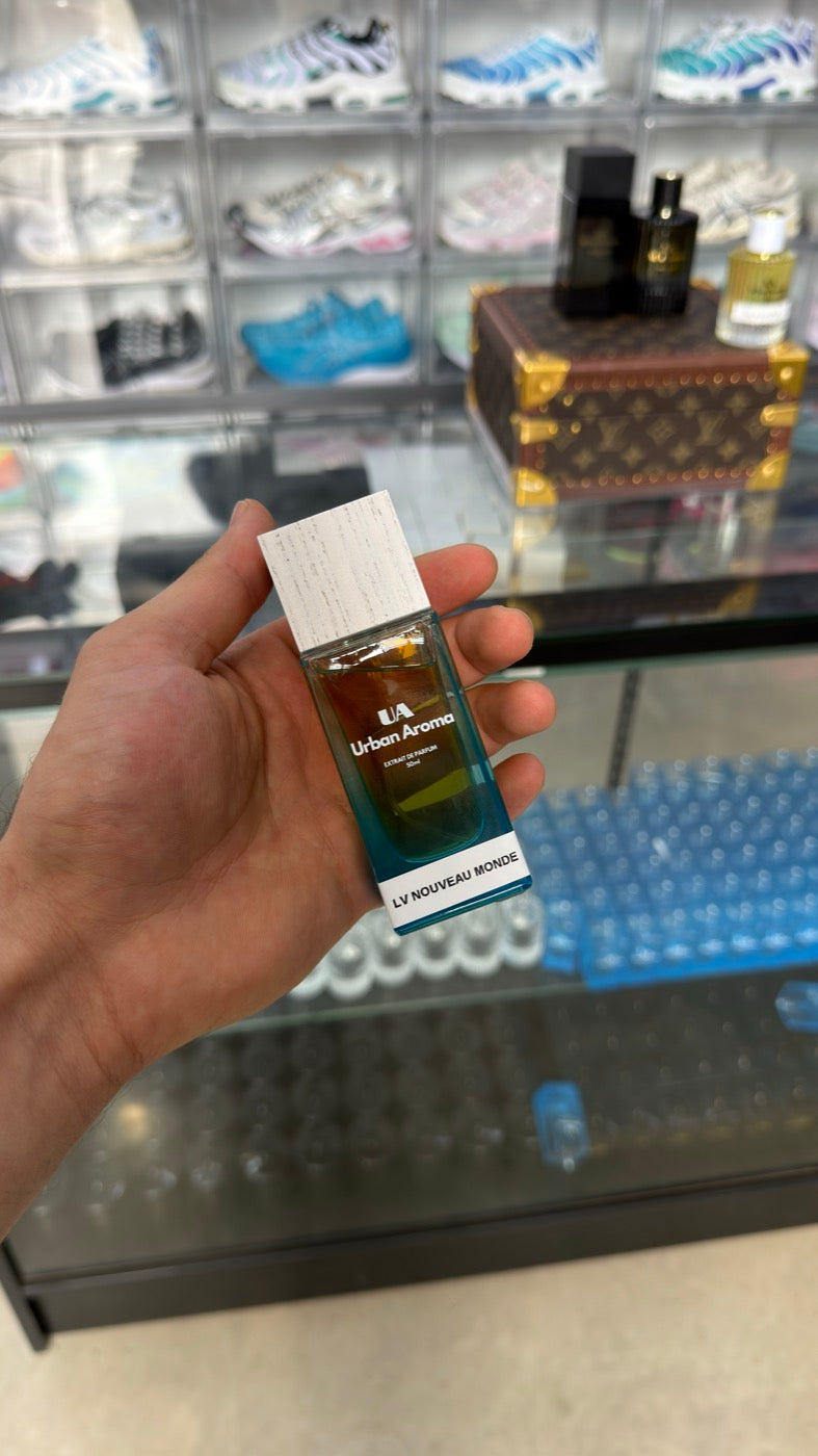 Urban Aroma blue glass 50 ml bottle with a silver cap, photographed in the shop